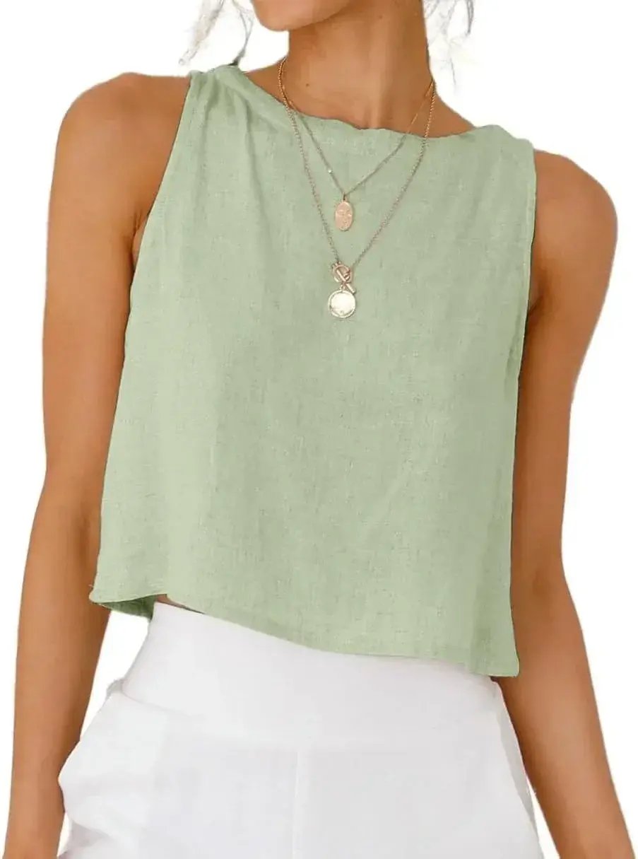 Mint green sleeveless crop top with relaxed fit, paired with white pants and layered necklaces for casual summer style